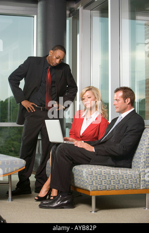 Business executives working together on laptop Stock Photo
