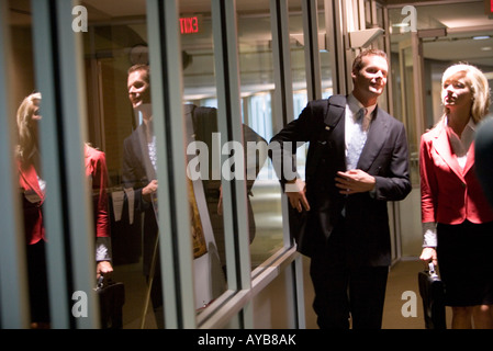 Business people walking and conversing in an office hallway Stock Photo