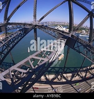 View from within the metal girder superstructure of Sydney Harbour Bridge with Bennelong Point and Opera House Sydney Australia Stock Photo