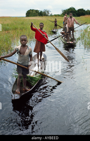 Children of Libinza ethnic group going to school by canoe Ngiri river region Democratic Republic of the Congo ex Zaire Africa Stock Photo