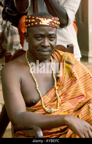 Village chief draped in hand woven ceremonial Kente cloth garment in Ghana Africa Stock Photo