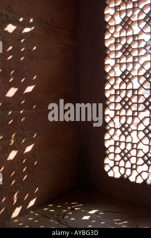 Sun streaming through trellis fret work called Jalis at Fatehpur Sikri Fort. Part of Fatehpur Sikri, known as the deserted city. Near Agra, India. Stock Photo