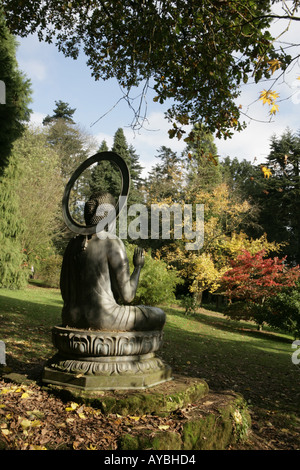 A statue of buddha at  the Batsford Arboretum near Moreton in Marsh has a collection of over 1,000 different trees and shrubs Stock Photo