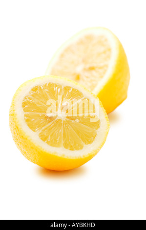 Single lemon cut in half against white background Stock Photo