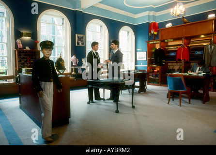 Upstairs interior of Gieves Hawkes bespoke gentlemens attire Master Tailors inspecting cloth samples Savile Row London England Stock Photo