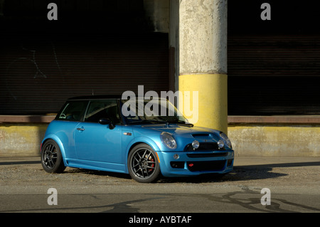 Customized MINI Cooper S parked in front of an abandoned factory in Detroit Michigan Stock Photo