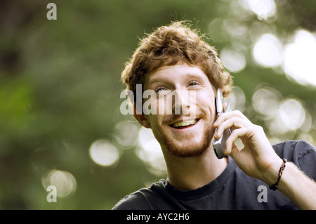 Smiling red haired man talking on cell phone Stock Photo