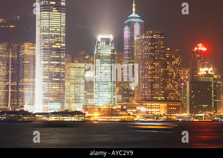Boats Passing In Front Of Central District, Hong Kong Stock Photo
