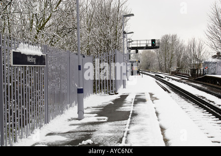 Snow on a London railway platform and tracks. Stock Photo