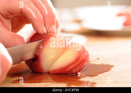 chef making poached pears in mulled wine with honey and vannila ice cream Stock Photo