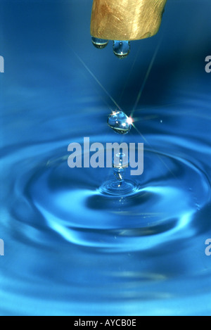 Drop of water and tap faucet Stock Photo