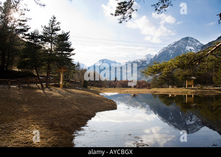 Alpine pond with nice reflections formed by the melted snow. Le Motte, Valtellina, Italy Stock Photo