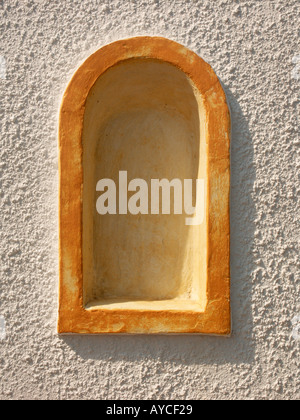 An orange plaster alcove on a rough wall at the Eden Project Stock Photo