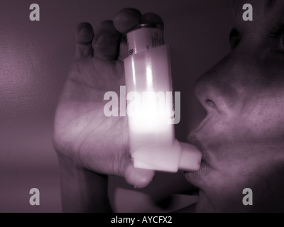 Woman using athsma inhaler Stock Photo