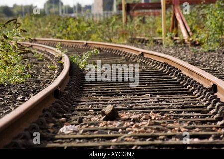 Closeup of an old rusty railway track along the riverside in Dundee, UK Stock Photo