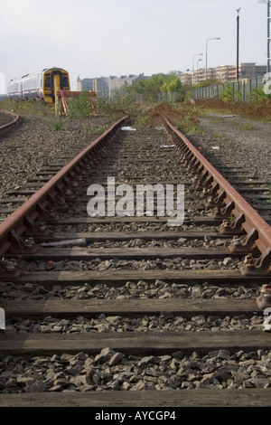 Rusty railway line of the GNER Great Northeastern Railway along the riverside in urban Dundee, UK Stock Photo