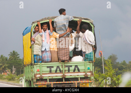 Farm workers returning from labouring in the fields crammed into the back of a Tata lorry Stock Photo