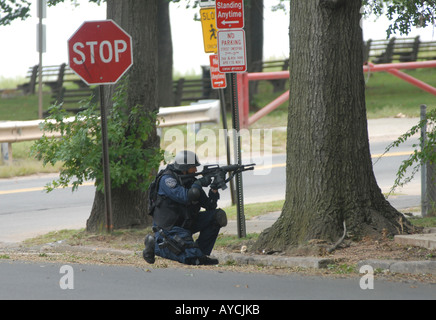 A Swat Team Member takes aim during a possible standoff with an armed assailant Stock Photo