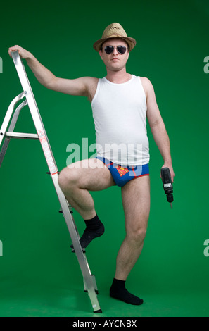 man doing diy in superman pants Stock Photo