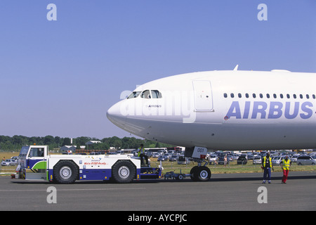 Airbus A340 600 being pushed back by Douglas aircraft tug at Farnborough Airshow Stock Photo