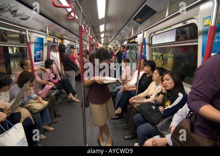 A crowded subway carriage on the Hong Kong metro MTR, Hong Kong, China Stock Photo
