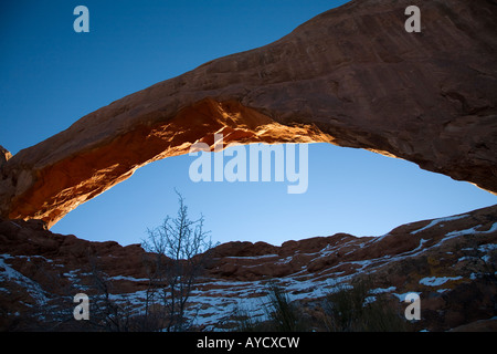 Sunset glow on South Window from the backside in winter snow at Arches National Park Stock Photo