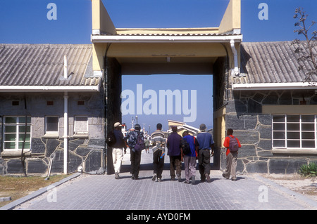 Black African workers leaving Robben Island prison through main gate, South Africa Stock Photo