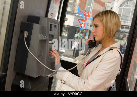 woman using a pay phone Stock Photo