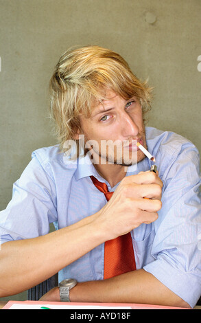 Office worker smoking a cigarette Stock Photo