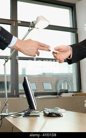 Businessmen exchanging cards Stock Photo