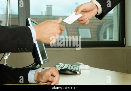 Businessmen exchanging cards Stock Photo