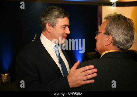 Prime Minister Gordon Brown MP chats to an attendee at a seminar in London Stock Photo