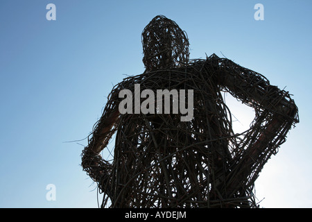 A wicker man against a blue sky. Stock Photo