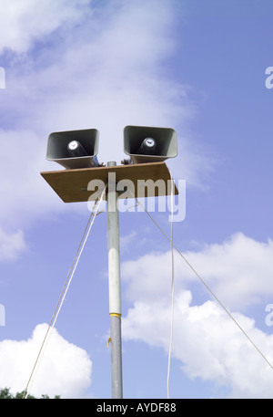 Loudspeakers on a pole with sky in the background at a fete Stock Photo