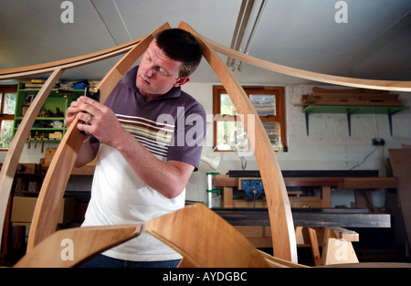 a cabinet maker using tools and working in his studio Stock Photo