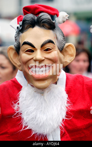 Person wearing Tony Blair mask dressed as Santa Claus for the annual charity Santa Fun Run at Newtown Powys Wales UK Stock Photo