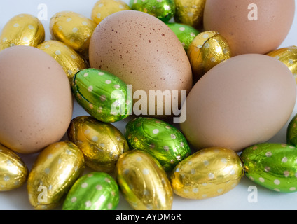 Foil covered Easter eggs amongst normal eggs Stock Photo
