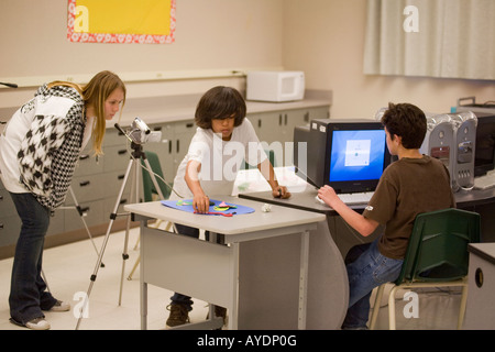 Caucasian and Hispanic students  in middle school computer class Stock Photo