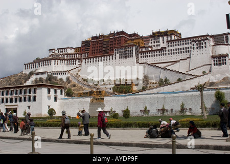 Tibetan pilgrims walking in front of the Dali Lama's Potala Palace in Lhasa Tibet during a religious holiday Stock Photo