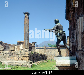 Pompeii, Italy.  Statue of Apollo the Archer in courtyard of temple of Apollo.  Mount Vesuvius volcano behind. Stock Photo