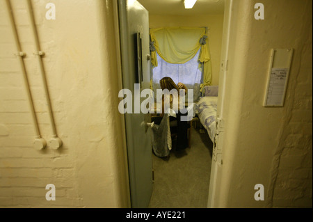 A female prisoner brushes her hair in her cell at Brockhill women s prison in Redditch Worcestershire UK