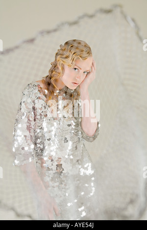 Young woman as fish caught in net Stock Photo