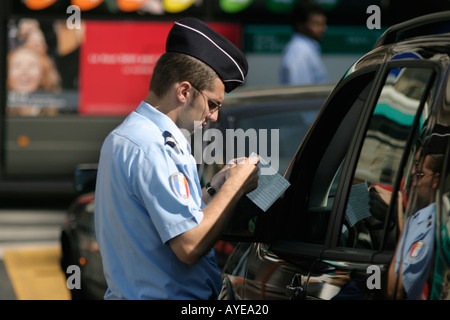 Policeman inspecting driver's documents in the centre of Paris France Stock Photo