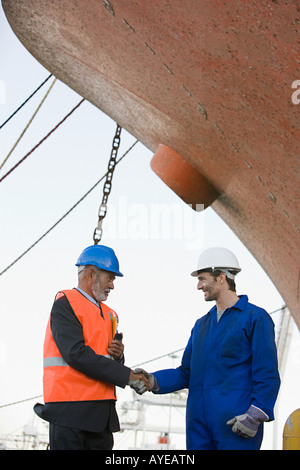 Workers shaking hands Stock Photo