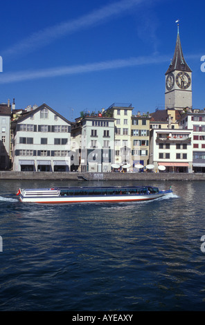 Excursion boat at Limmat river in front of Wuehre bank and St Peter church in Zurich Switzerland Stock Photo