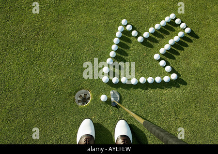 An arrow pointing to a hole on a golf grees Stock Photo