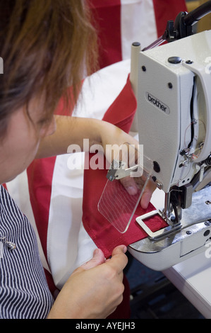 Woman worker machine sewing american flag in factory Stock Photo