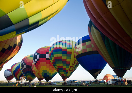 Rows of hot air balloons in ready for launch with deep blue sky and sunrise as background.  Albuquerque Balloon Fiesta in Stock Photo