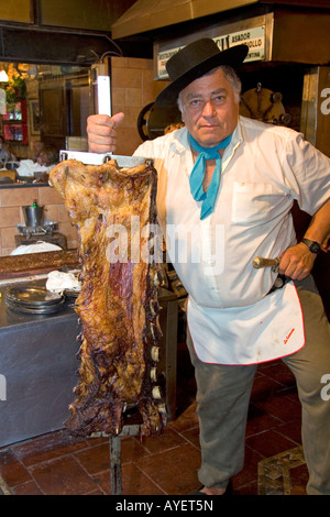 Argentine man cooking beef at a restaurant in Buenos Aires Argentina Stock Photo