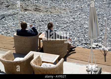a young couple enjoying sunny afternoon on the beach in Nice, South France Stock Photo
